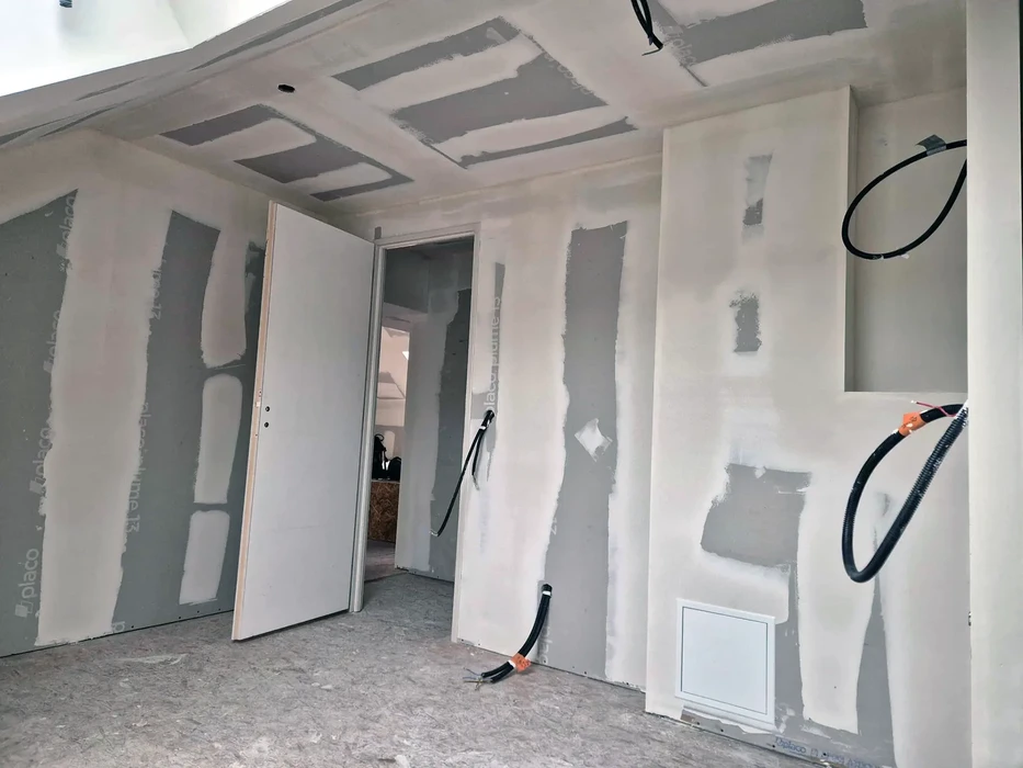 Chantier de rénovation intérieure en cours avec cloisons en plaques de plâtre partiellement installées